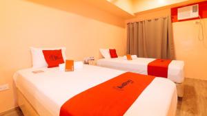 Postel nebo postele na pokoji v ubytování RedDoorz Plus @ Kaizen Suites Taft Avenue