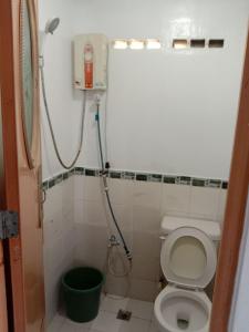 a small bathroom with a toilet and a shower at RedDoorz @ Isla Virginia Beach Resort Aurora Baler in Baler