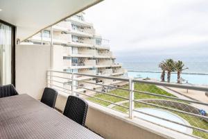 a balcony with a view of the beach and a building at San Alfonso del Mar Insuperable Vista in San Antonio