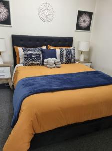 a bedroom with a large yellow bed with pillows at Nomads Rest in Gympie