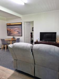 a living room with a couch and a table at Nomads Rest in Gympie