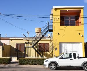 a white car parked in front of a yellow building at Luisito in Santa Rosa