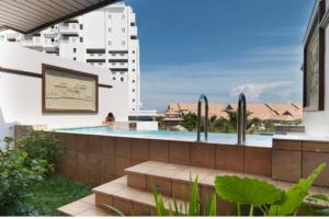 a swimming pool in the backyard of a building at Grand Lexis Port Dickson in Port Dickson