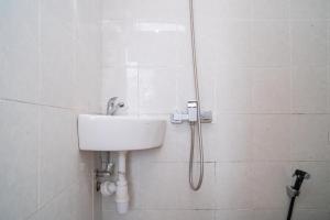 a shower in a bathroom with a sink at RedDoorz @ Aralia Harapan Indah in Pulokendal +33 photos