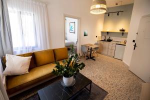 a living room with a couch and a table at Julia's Hotel Suites in Amman
