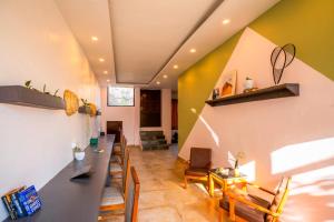 a dining room with a long table and chairs at Zostel Banikhet (Dalhousie) in Dalhousie