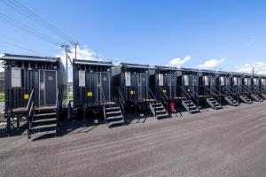 a row of portable toilets in a parking lot at HOTEL R9 The Yard Miyakonojo in Miyakonozyō