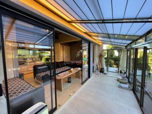 a glass extension of a house with a living room at KandoStay 伊豆高原パークガーデン in Ito