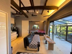 a living room with a couch and a bed at KandoStay 伊豆高原パークガーデン in Ito