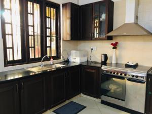 a kitchen with a sink and a stove top oven at Cinnamon Villa in Matara