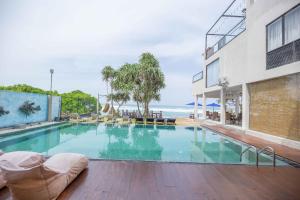 a large swimming pool with a view of the ocean at Beach & Bliss Mirissa in Mirissa