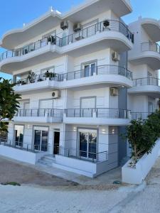 an apartment building with balconies on the beach at Dani's Apartments in Sarandë