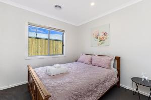 a bedroom with a bed and a window at Park View in Port Fairy
