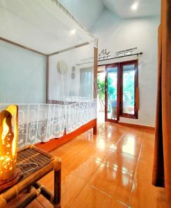 a living room with a bed and a wooden floor at Sumatra Orangutan Discovery Villa in Bukit Lawang