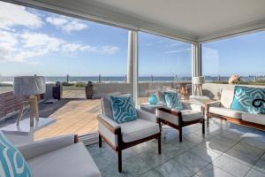 a living room with a view of the ocean at Sandy Cove in Port Fairy