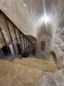 a staircase in a stone building with a stair case at Qandeel - Dar Botto in Bethlehem