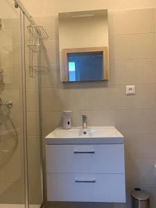 a bathroom with a sink and a shower at Apartman Juraj in Liptovský Mikuláš