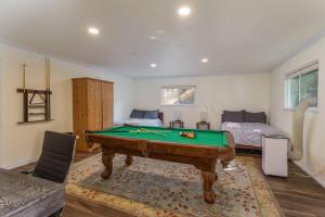 a bedroom with a pool table and a bed at Acorn House - Charming house in green heaven with pool table with lovely backyard in Oakhurst
