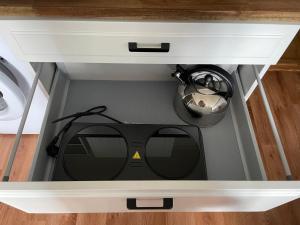 a drawer with a pair of sunglasses in it at Nice apartment in Maardu in Maardu