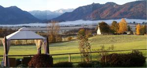 eine Hochzeitszeremonie auf einem Feld mit Bergen im Hintergrund in der Unterkunft Georgihof Ferienwohnungen in Murnau am Staffelsee