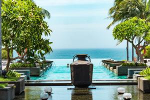 a pool at a resort with a vase in the water at Narada Resort & Spa Perfume Bay Sanya - All Villas in Lingshui