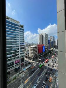 a view of a busy city street with traffic at Hongdae Residence 3 - 1min from Hongik Uni station Exit #1 in Seoul