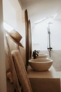 a row of three sinks in a bathroom at La Isla Bonita Gili Air in Gili Air