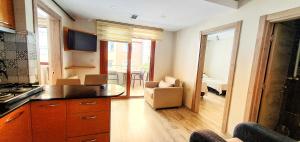 a kitchen with a couch and a chair in a room at İnce Apart Rezidence in Trabzon