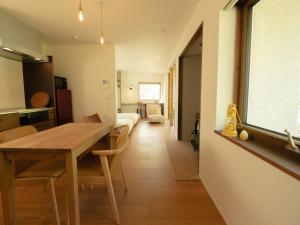 a kitchen and dining room with a table and chairs at Coboushi ハナレ in Niseko