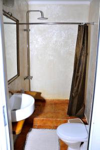 a bathroom with a toilet a sink and a bath tub at Art House Sweet home in Shymkent