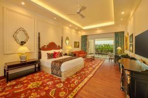 a bedroom with a bed and a living room at MAYFAIR Tea Resort in Siliguri