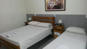 Łóżko lub łóżka w pokoju w obiekcie Parque Hotel