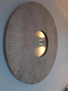 a circular mirror on the ceiling of a room at Au coucher du lac in Publier