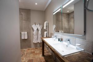 a bathroom with a sink and a mirror at Le Manoir des Impressionnistes - Bord de Mer in Honfleur