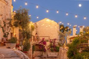 a string of lights hanging over a building with stairs at Masseria San Paolo Grande in Ostuni