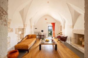 a living room with a couch and a table at Masseria San Paolo Grande in Ostuni