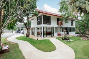 a house with a walkway in front of it at Prinz Garden Villa in Hua Hin
