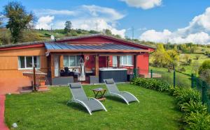 a house with two chairs and a table in the yard at OVIEDO REAL Spa in Oviedo