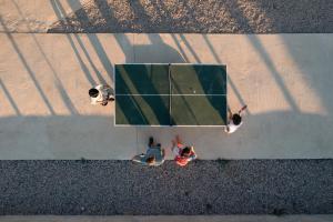 a group of people playing a game of tennis at Terra Park Phalaris in Novalja
