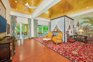 a living room filled with furniture on top of a red rug at MAYFAIR Tea Resort in Siliguri