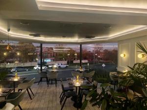 a restaurant with tables and chairs and a view of a street at The Charles Boutique Hotel & Dining in Wagga Wagga