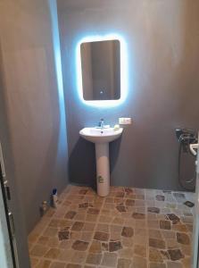 a bathroom with a sink and a mirror at Lento Kaldani Guesthouse in Adishi +23 photos