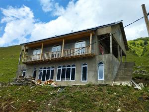 a house on top of a hill at Lento Kaldani Guesthouse in Adishi