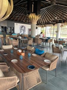 una sala da pranzo con tavolo e sedie in legno di Joets Guesthouse a Bogmalo