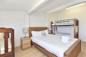 a bedroom with two bunk beds and a lamp at Sunshine Shores in Morisset East