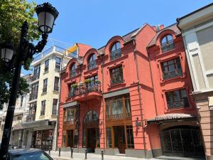 a red building on the side of a street at Villa Flavia Heritage Boutique Hotel in Plovdiv
