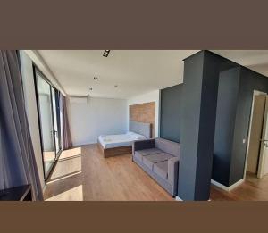a large room with a bed and a large window at Le Rêve Boutique Hotel in Dhërmi