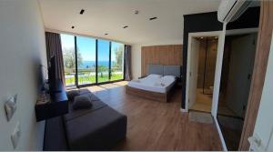 a large bedroom with a bed and a large window at Le Rêve Boutique Hotel in Dhërmi