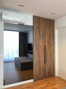 a room with a sliding door with a bed in it at Le Rêve Boutique Hotel in Dhërmi