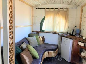 a room with a couch in a tiny house at Sherman's place - שרמנ'ס פלייס in Melilot